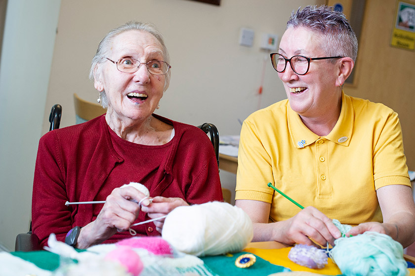 Resident Elsie Knott and Toni Carrigan knitting together