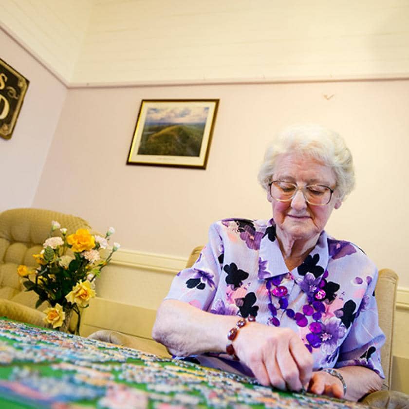 Beechwood resident doing a puzzle