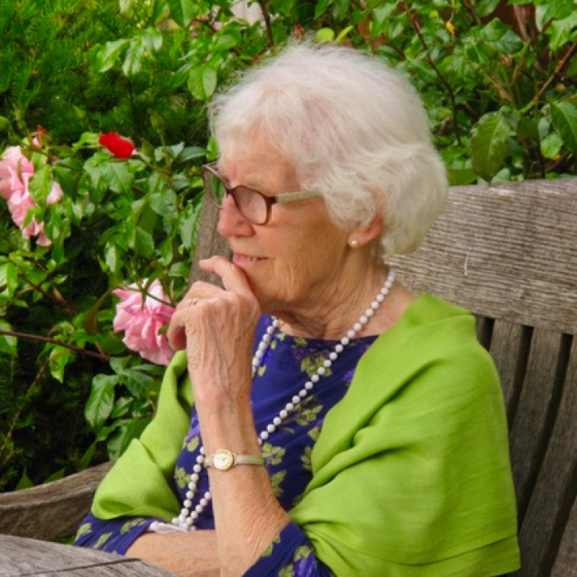 A resident sits in the lovely gardens at Briggs House 